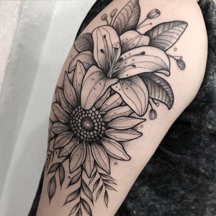 a black and white photo of a flower on the arm