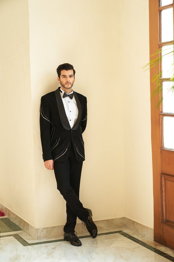 Soul Black Tuxedo Set - Contrast by Parth Minimal yet blingy, a tuxedo set made to perfection Included in purchase: Jacket, Kurta and Pants Product Specification Color: Black (can be customized) Fabric: Italian Suiting Occasion: Formal Event, Wedding, Bridal, Reception Style: Tuxedo Designer: Contrast by Parth Care: Dry Clean Only Work: Hand Embroidered, Mirror ( Variation in color, fabric & detail is possible. Model images are only representative.) This can be customized in any color, size or s Designer Fitted Bandhgala For Evening, Fitted Blazer For Black-tie Festive Events, Festive Fitted Blazer For Black-tie Events, Festive Fitted Tuxedo For Black-tie Events, Tailored Embellished Sets For Party, Tailored Tuxedo Party Sets, Tailored Sets For Black-tie Festive Events, Tailored Evening Party Wear Suits, Fitted Tuxedo Sets For Parties