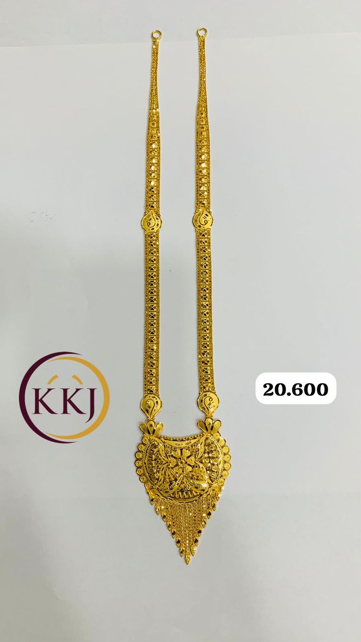 two gold necklaces on display in front of a white background with the kj logo