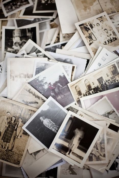 old black and white photographs are scattered on top of each other in this pile,