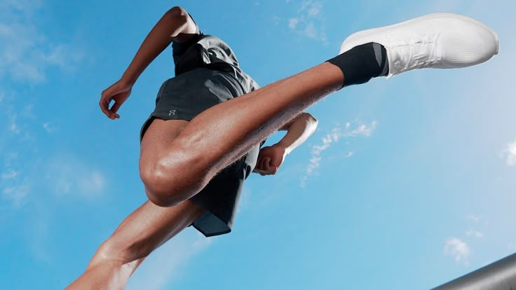 a person jumping in the air with their feet up and one leg on his hip