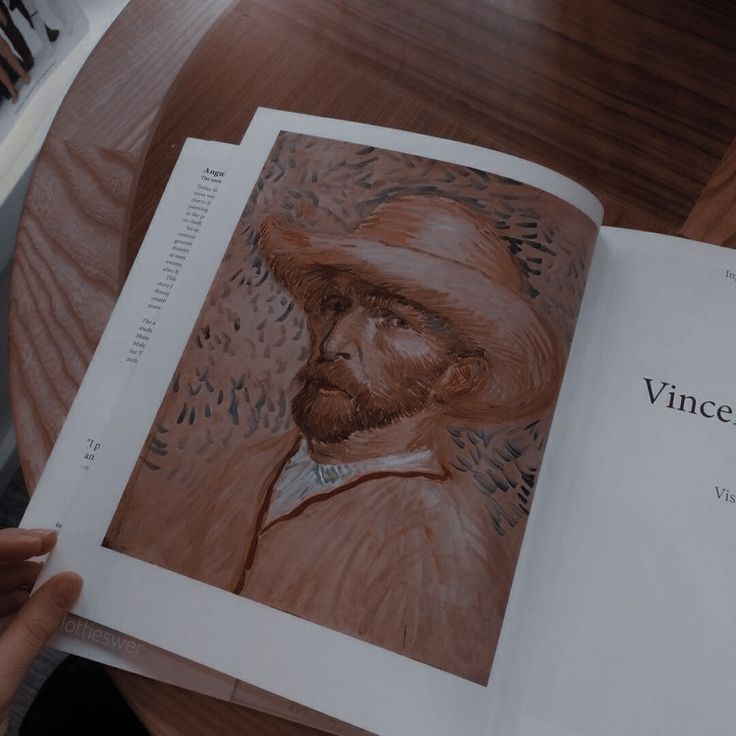 an open book with a drawing of a man wearing a hat