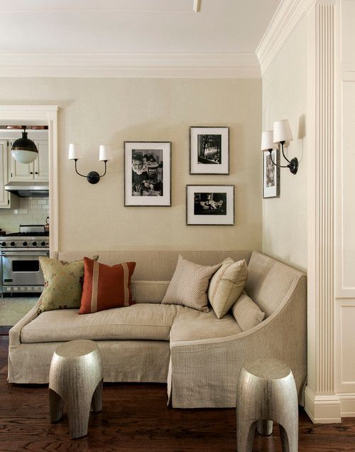 a living room filled with furniture and pictures on the wall