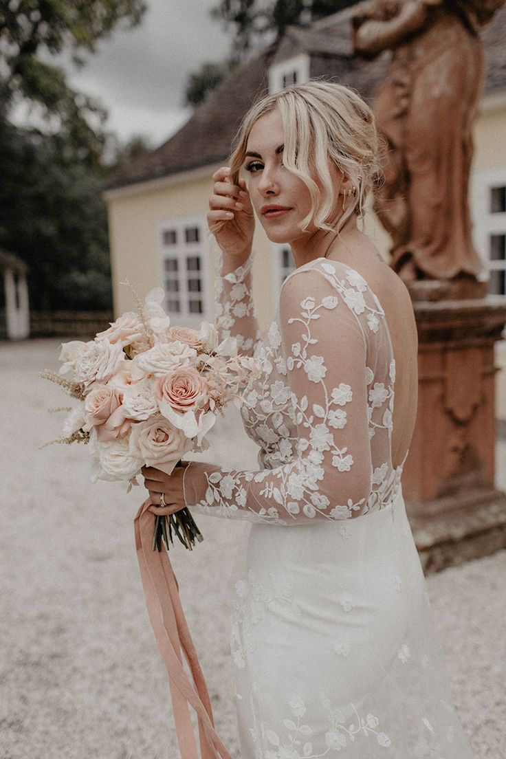 a woman in a wedding dress holding a bouquet