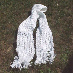 a pair of white knitted scarves laying on the ground