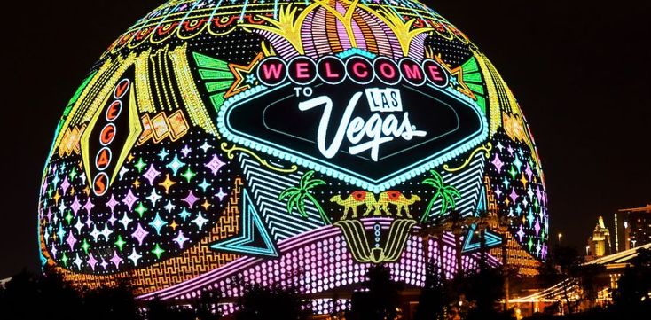 the las vegas sign lit up at night