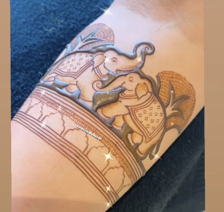 the arm is decorated with an elephant on it