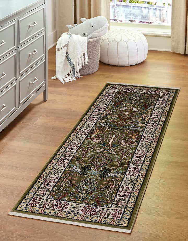 a large rug is on the floor in front of a dresser with drawers and an open window