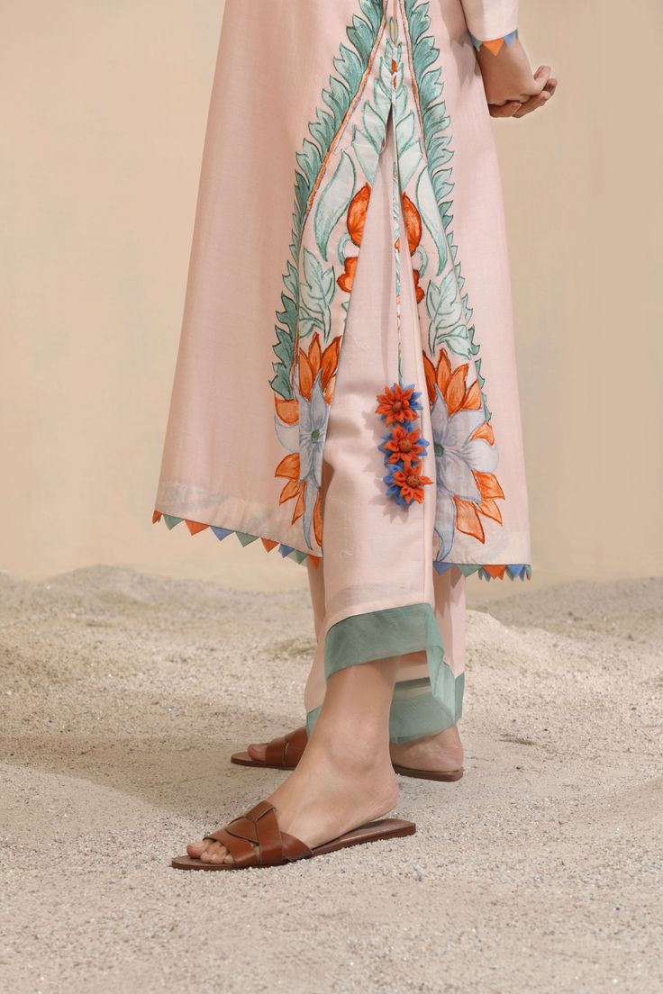 Luxuriously breathable with exaggerated placement prints on the sides inspired bythe evergreen Chinar, paired with free to move in trousers elevated with simplisticdesign detailing, the Bouin Kurta & Co-ord Set is your go-to all season and all yearround. The Kurta carries a trail of noticeably enjoyable contrasting lacework andinterestingly placed flowered side tassels, making it easy to dress down for casualbrunches and to dress up for evening soirees. COLOR: Light Peach FABRIC: Top - Bottom -CHANDERI COMPONENTS: 2 Delivery Time: 15 days CARE: Dry clen only Festive Semi-stitched Sets With Printed Border, Printed Co Ord Set Designs Pakistani, Printed Co Ord Set Design, Printed Co Ord Set Pakistani, Printed Linen Co Ord Set, Shirt Jacket Men, Trouser Co Ord, Drape Saree, Co Ord Set