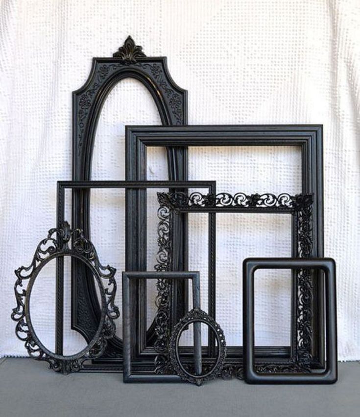 an assortment of ornate black frames against a white background