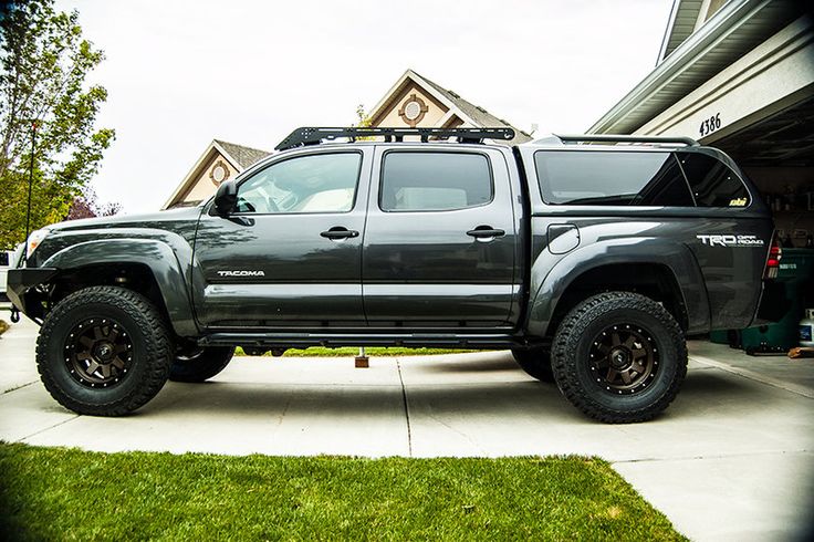 a black truck parked in front of a house