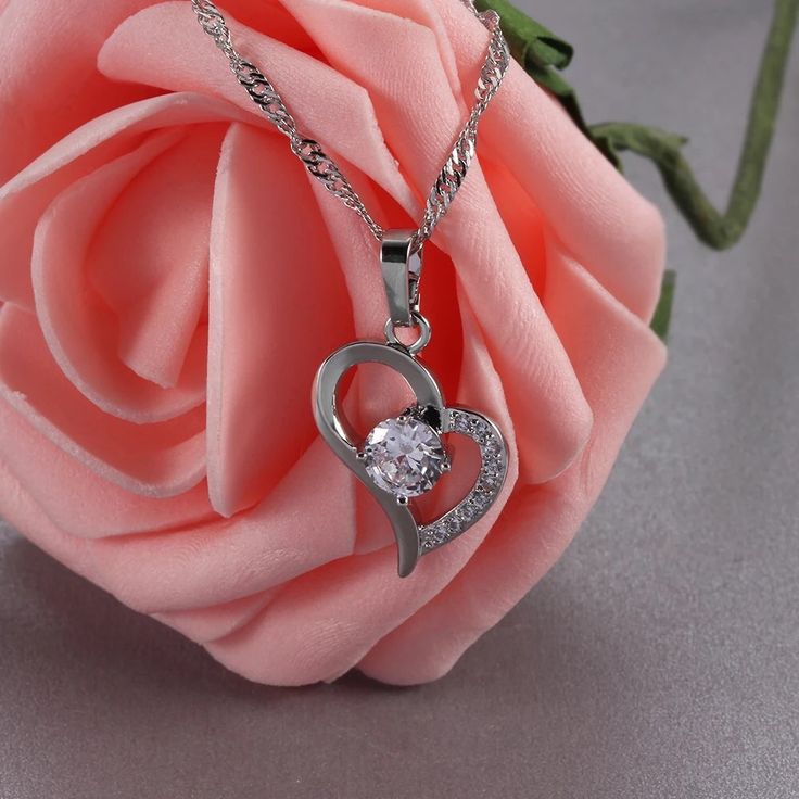 This Necklace Is A Diamond Cut Twisted Stainless Steel Chain Featuring A Sparkly Heart Pendant With 9 Small Cubic Zirconia And 1 Large, About 1 Carat At The Center Brand New Never Worn Chain Length 18” Can’t Afford A Diamond Well This Perfect And Makes A Great Gift For Your Special Person! Just As Sparkly As A Diamond, And Shhh No One Has To Know! Mother's Day Silver Crystal Heart Necklace, Cubic Zirconia Heart Necklace For Her, Cubic Zirconia Heart Necklace Gift For Her, Silver Crystal Heart Necklace For Anniversary, Valentine's Day Cubic Zirconia Heart Necklace With Clavicle Chain, Valentine's Day Heart Necklace With Cubic Zirconia Clavicle Chain, Mother's Day Crystal Heart Pendant Necklace, Mother's Day Heart Pendant Crystal Necklace, Heart Cut Diamond Accents Necklace For Her