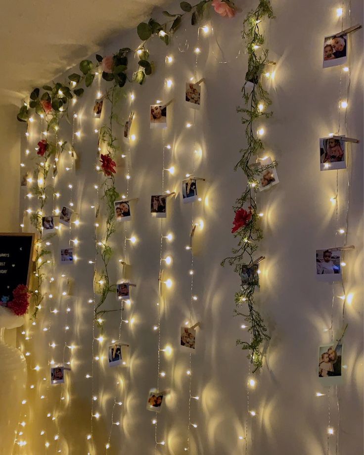 a wall with lights and pictures hanging on it