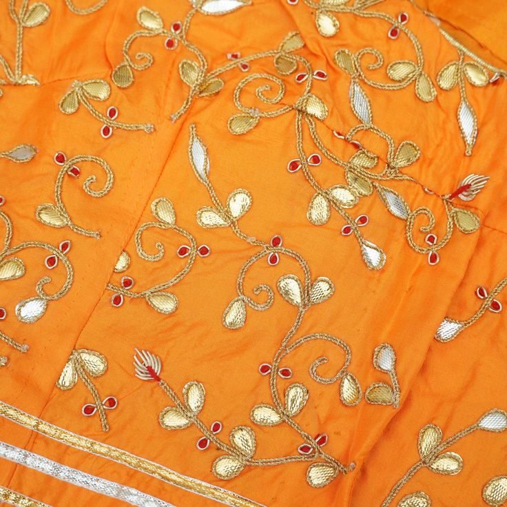 Category: Banarasi Fabric Khinkhwab brings you beautiful fabrics with intricate gotta patti embroidery. All the measurements are shown in the picture. This is 38 chest blouse. Non-padded. Fabric: Pure Silk Note- There may be slight color variations due to photographic reasons. This is a hand-woven product and any irregularities in the weaving or pattern should not be taken as a defect. These irregularities make every handloom piece unique. Semi-stitched Embroidered Choli For Traditional Ceremonies, Embroidered Semi-stitched Choli For Traditional Ceremonies, Bollywood Style Embroidered Choli For Traditional Ceremonies, Gold Silk Fabric With Dori Embroidery, Traditional Semi-stitched Blouse Piece With Gota Work, Orange Raw Silk Traditional Wear With Gota Work, Navratri Chanderi Blouse Piece With Multicolor Embroidery, Festive Silk Fabric With Gota Embroidery, Festive Silk Embroidered Fabric With Gota Work