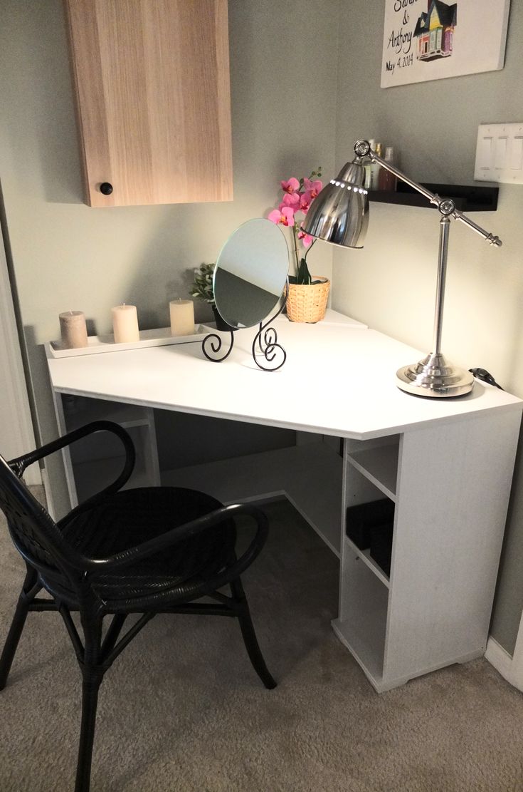 a white desk with a black chair in front of it