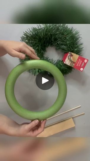 someone is making a wreath out of fake grass