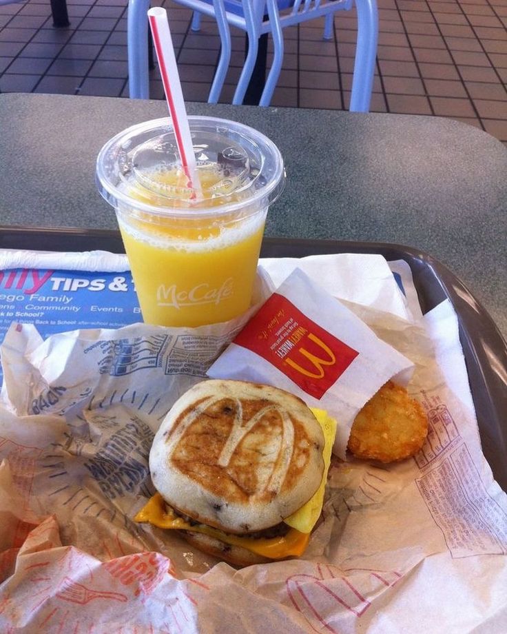 a tray that has some food on it and a cup with a drink in it