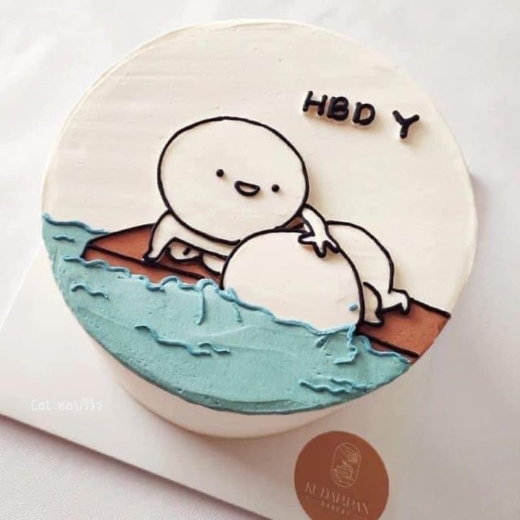 a cake decorated with an image of a man and a whale