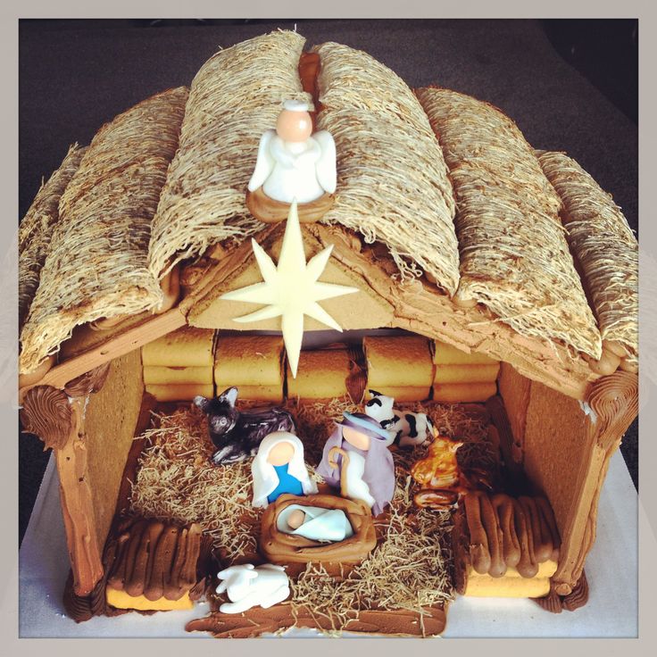 a nativity scene made out of wood and straw with a star above the manger