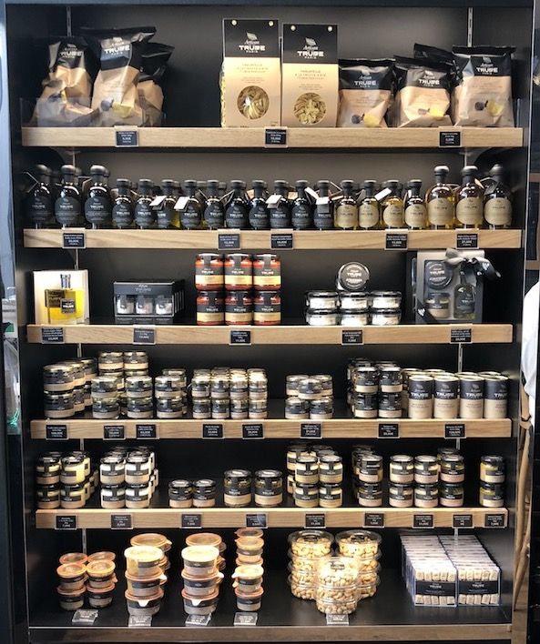 the shelves are filled with many different types of food and drinks, including coffee beans