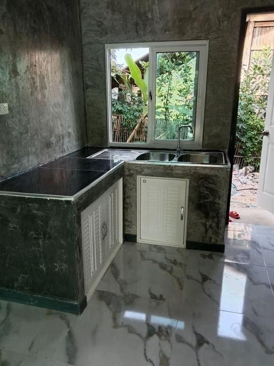 an empty kitchen with marble counter tops and white appliances in the middle of the room