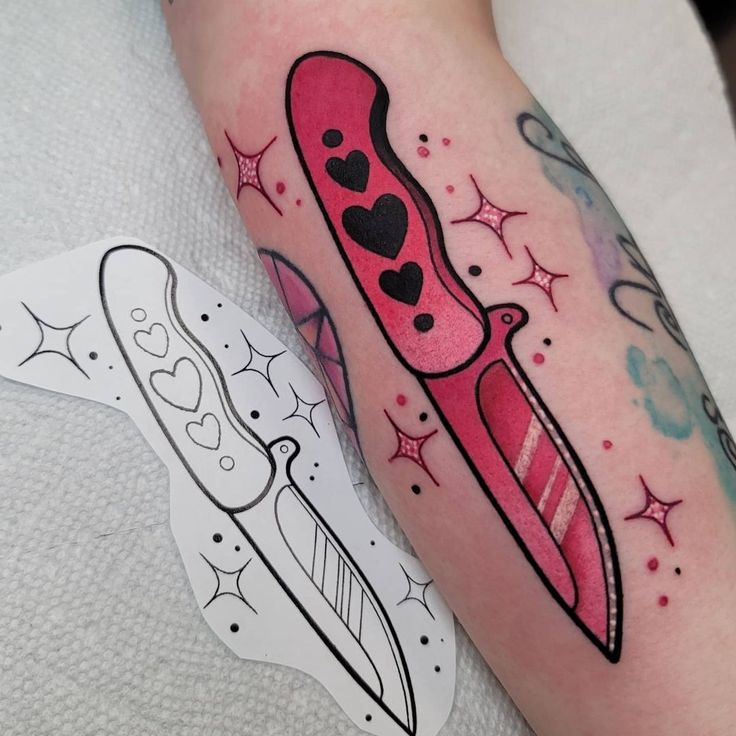 a tattoo on the leg of a person with a knife and heart shaped object in it