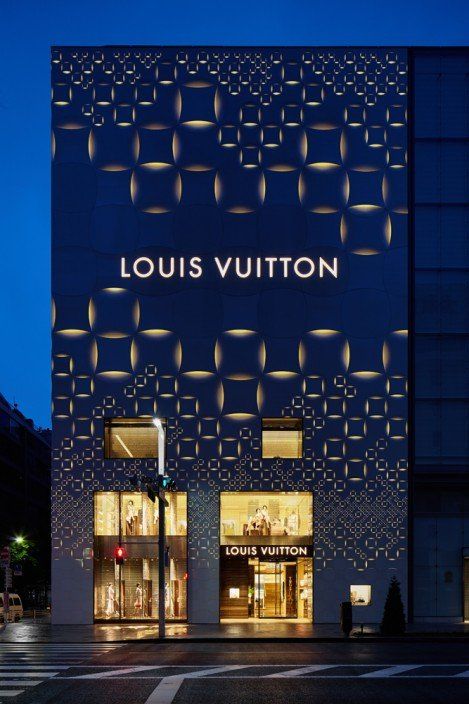 the louis vuitton store in paris is lit up at night with its lights on