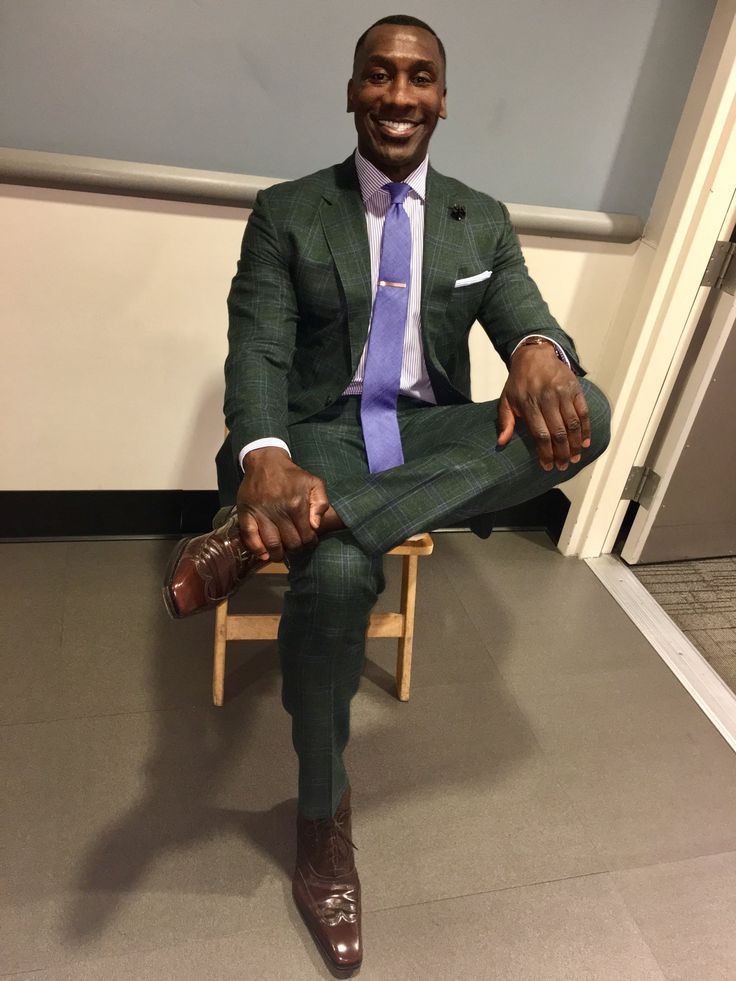 a man in a suit and tie sitting on a chair