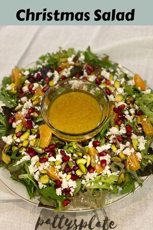 a salad on a plate with dressing in it and the words christmas salad written below