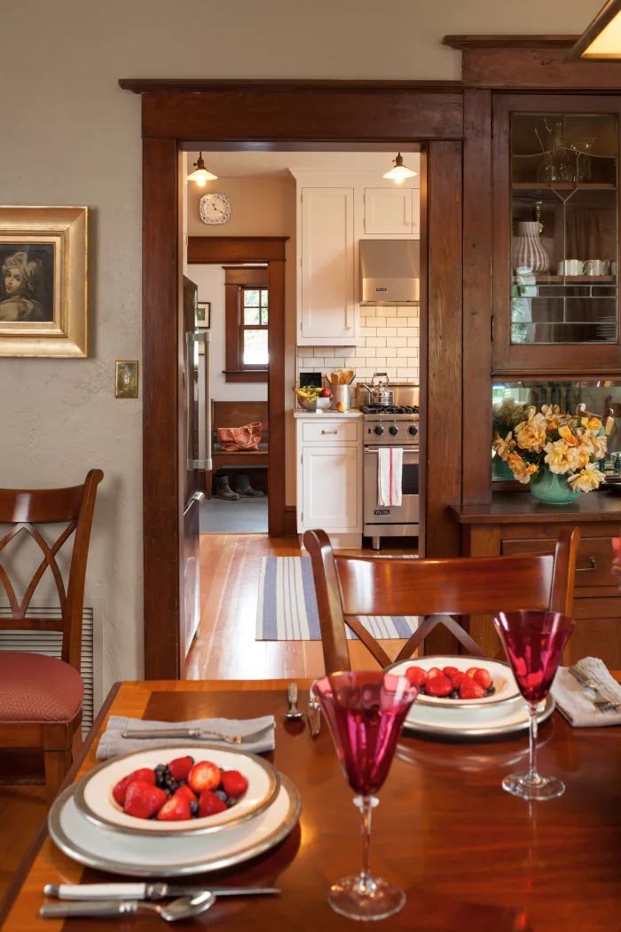 a dining room table with plates and glasses on it