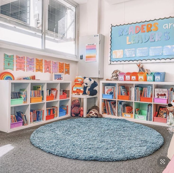 a child's playroom with bookshelves, rug and stuffed animals on the floor