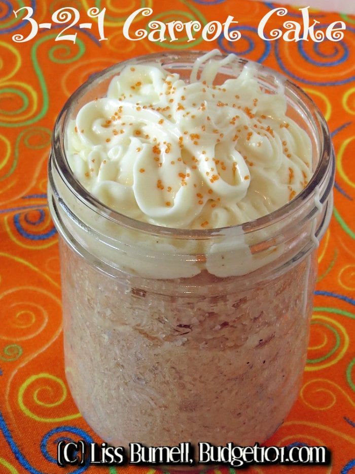 there is a small glass jar filled with cake and whipped cream on the counter top