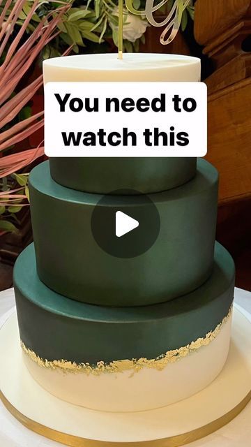 a three tiered cake with the words you need to watch this