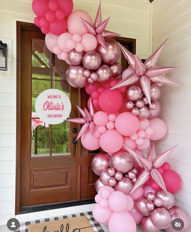 a bunch of balloons that are on the side of a door