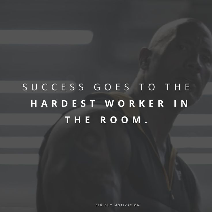 a man standing in front of a wall with the words success goes to the hardest worker