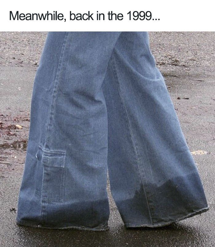 a person standing in the street with their feet up and wearing jeans that have been worn by someone