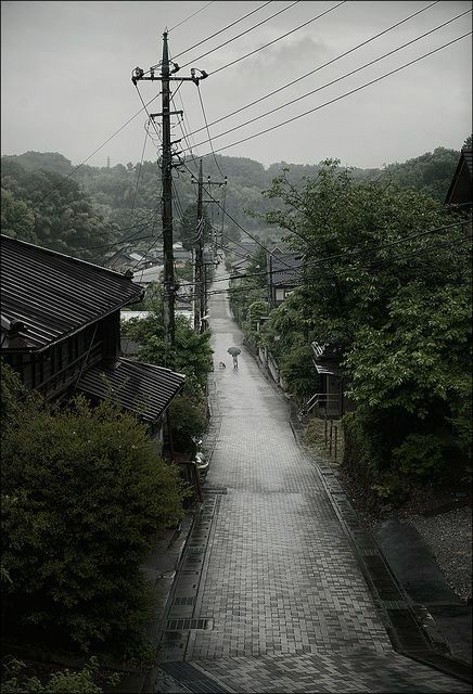 an empty street with power lines above it