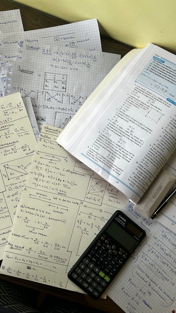 a calculator sitting on top of papers with calculations written in them and a pen