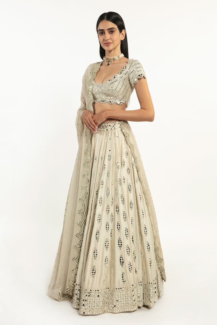 Ivory chanderi lehenga with gota, resham and mirror embroidery. Paired with embroidered blouse and scallop dupatta.
Components:3
Pattern:Embroidered
Type of Work:Gota, Resham, Mirror
Neckline:Scoop
Sleeve Type:Short Sleeves
Fabric:Lehenga-Chanderi , Blouse: Raw Silk, Dupatta: Polka Georgette 
Color:Ivory
Other Details:
Scallop dupatta
Closure:
Lehenga: Side zip
Occasion:Bride, Destination Wedding - Aza Fashions Scallop Dupatta, Chanderi Lehenga, Abhinav Mishra, Mirror Embroidery, Bridal Lehengas, Indian Wedding Outfits, Silk Dupatta, Bridal Lehenga, Embroidered Blouse