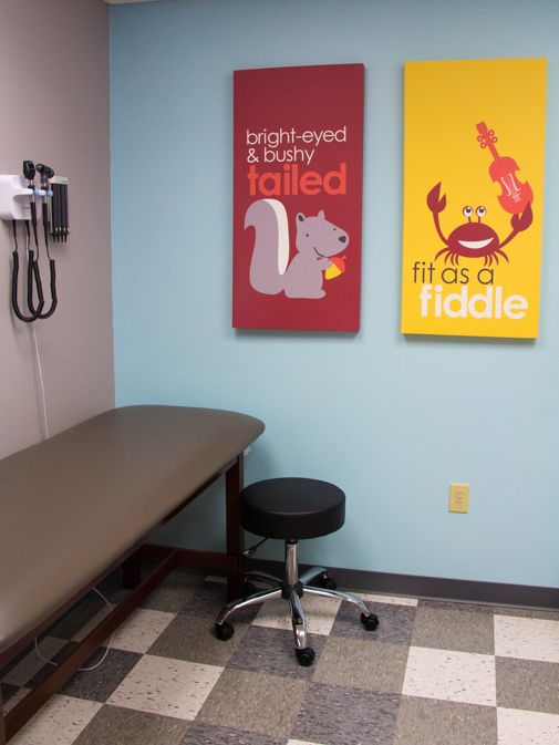 a hospital room with two posters on the wall