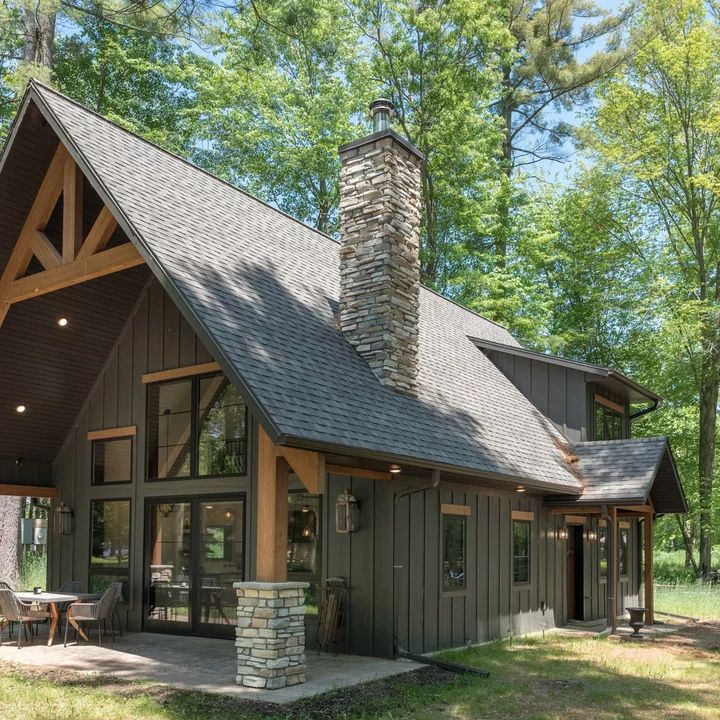 a house with a stone chimney in the front yard