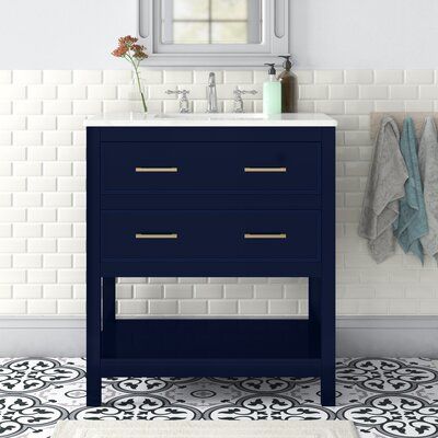 a bathroom with a sink, mirror and blue cabinet in the middle of the floor