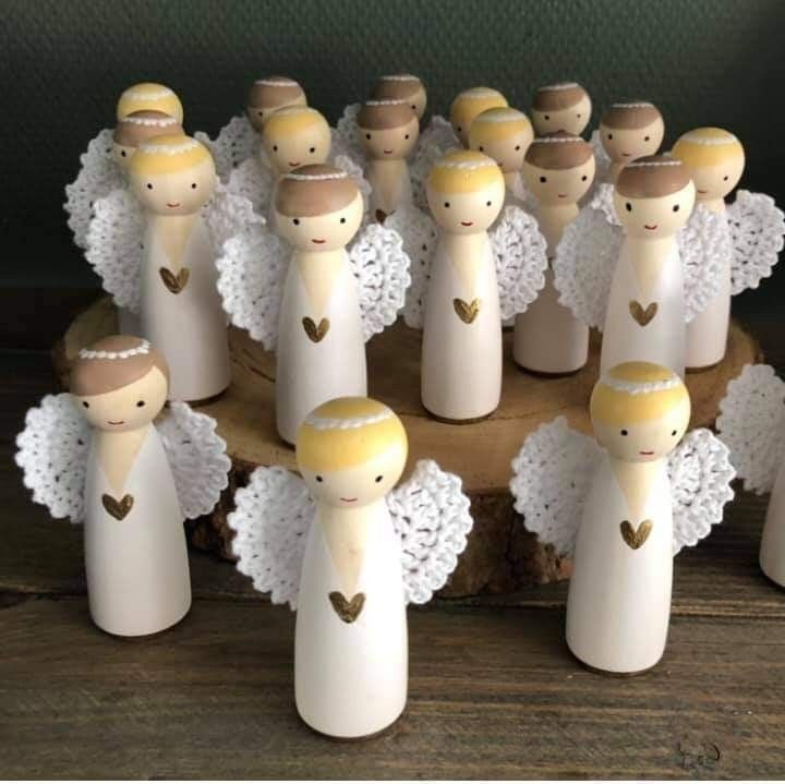 a group of wooden peg dolls with hearts on them