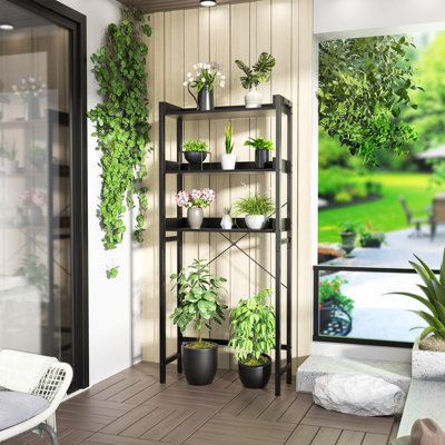 a room filled with potted plants next to a sliding glass door