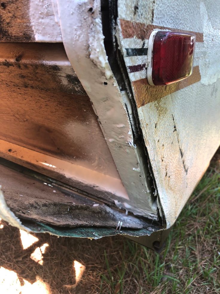 the side of an old car with rust on it