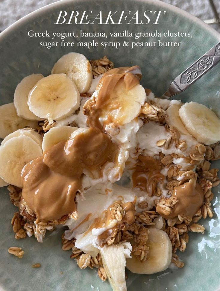 a bowl filled with granola, bananas and yogurt on top of it