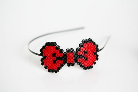 a pair of headbands with red and black beads in the shape of hearts