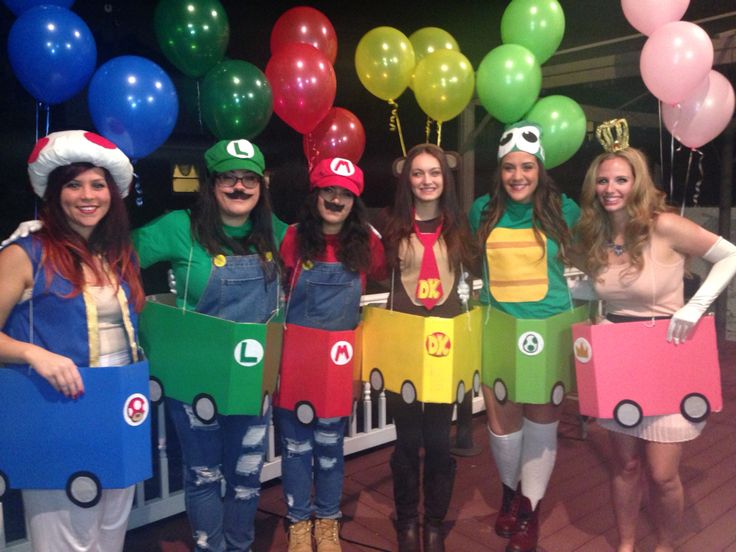 some people are dressed up as mario and luigi