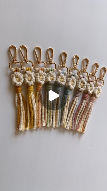 a row of different colored cords with gold clips on top of each one and an arrow in the middle