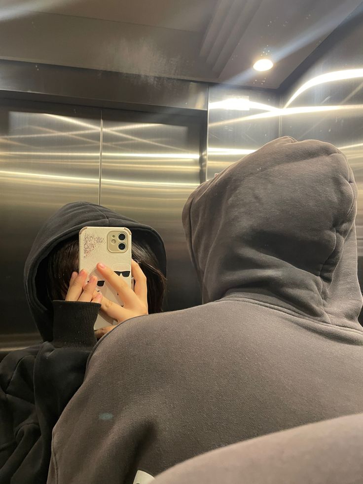 a person taking a selfie in an elevator